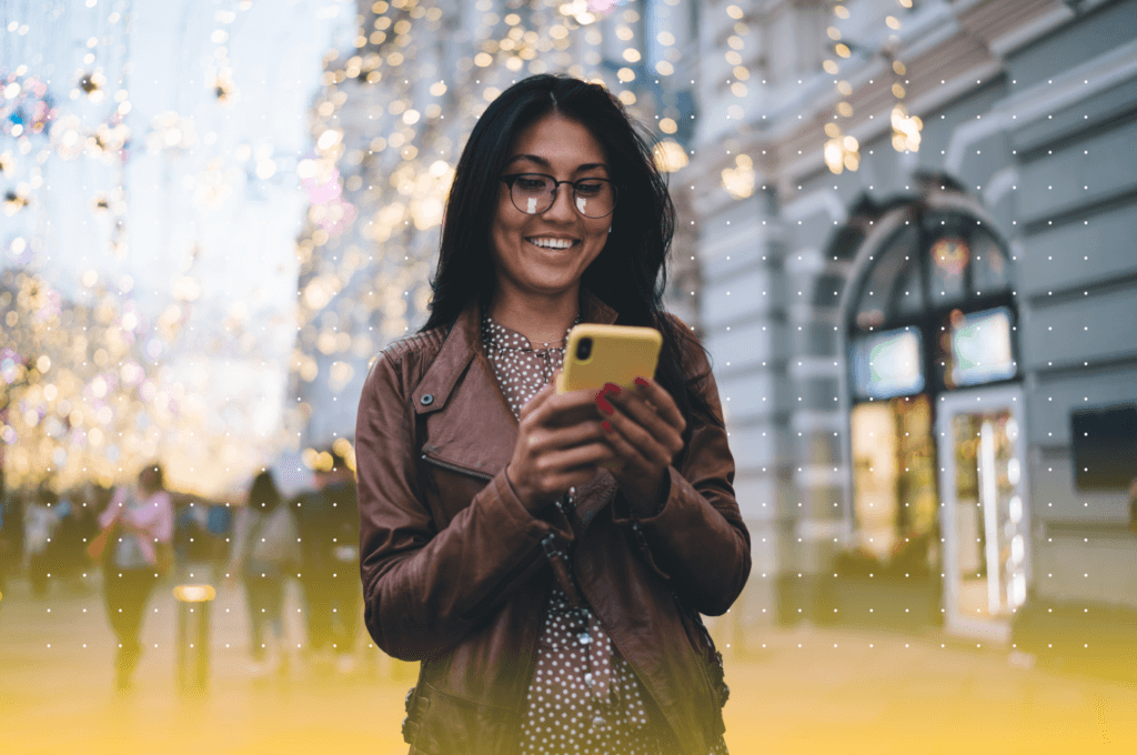 image of girl with glasses smiling at phone